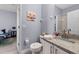 Light and airy bathroom with a granite vanity and updated fixtures at 487 La Mirage St, Davenport, FL 33897