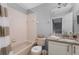 The bathroom has an integrated tub and shower, plus a vanity with nice granite counters at 487 La Mirage St, Davenport, FL 33897