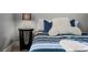 A clean bedroom with neutral colors includes a padded headboard and comfy pillows at 487 La Mirage St, Davenport, FL 33897