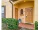 Charming condo entrance featuring well-manicured landscaping and a welcoming, covered doorway with the address 487 at 487 La Mirage St, Davenport, FL 33897