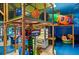 Indoor playground with a jungle gym, ball pit, and various ride-on toys for children to enjoy at 487 La Mirage St, Davenport, FL 33897