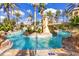 Resort-style pool area featuring a bridge, waterfalls, lush greenery, and inviting blue waters at 487 La Mirage St, Davenport, FL 33897