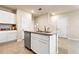 Kitchen with a granite countertop island, and white cabinets for ample storage at 512 Preston Cove Dr, St Cloud, FL 34771