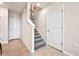 Staircase with carpeted steps and white railing, leading to the upper level, next to an entry door at 512 Preston Cove Dr, St Cloud, FL 34771