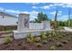 Stone monument sign displaying Preston Cove, surrounded by fresh landscaping, and a sidewalk leading into the neighborhood at 516 Preston Cove Dr, St Cloud, FL 34771