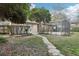 Serene backyard featuring a screened patio, lush landscaping, and a charming stone walkway at 5247 Secluded Oaks Dr, Orlando, FL 32812