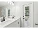 Bathroom featuring double vanity with black fixtures and a door to the backyard at 5247 Secluded Oaks Dr, Orlando, FL 32812