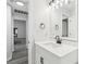 Bathroom featuring white vanity, framed mirror and matte black hardware at 5247 Secluded Oaks Dr, Orlando, FL 32812