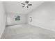 Bright bedroom with a ceiling fan, carpet, and natural light from window and doors at 5247 Secluded Oaks Dr, Orlando, FL 32812