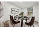 Elegant dining room featuring a glass-top table and a large window offering natural light at 5247 Secluded Oaks Dr, Orlando, FL 32812