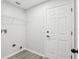 Laundry room with gray luxury vinyl plank flooring and white walls at 5247 Secluded Oaks Dr, Orlando, FL 32812