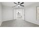 Spacious room with view into kitchen; ceiling fan, carpet at 5247 Secluded Oaks Dr, Orlando, FL 32812