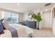 Inviting bedroom featuring a cozy bed, modern dresser, and lots of natural light from the large window at 532 Preston Cove Dr, St Cloud, FL 34771