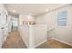 Upstairs hallway with carpet flooring, neutral wall colors, and natural light from a window at 532 Preston Cove Dr, St Cloud, FL 34771