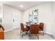 Dining area with a round glass table, leather chairs, and artwork adorning the walls at 5669 Brosnan Rd, St Cloud, FL 34771