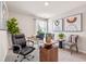 Comfortable home office featuring a computer desk, potted plants, wall art, and natural light at 5669 Brosnan Rd, St Cloud, FL 34771