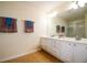 Double vanity bathroom featuring tile floors and a large mirror at 6855 Sperone St, Orlando, FL 32819