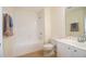 A standard bathroom features a shower over tub, and a vanity with storage at 6855 Sperone St, Orlando, FL 32819