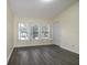 Bright bedroom with shuttered windows, wood-look flooring, and neutral wall color at 6855 Sperone St, Orlando, FL 32819