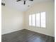 A bright bedroom features wood floors, white walls and vaulted ceiling with fan at 6855 Sperone St, Orlando, FL 32819