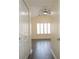 Hallway view of spacious bedroom with wood floors, vaulted ceiling and shuttered windows at 6855 Sperone St, Orlando, FL 32819