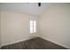 Empty bedroom featuring hardwood floors and a shuttered window at 6855 Sperone St, Orlando, FL 32819
