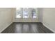 Bright bedroom with shuttered windows, wood-look flooring, and neutral wall color at 6855 Sperone St, Orlando, FL 32819