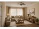 Bright living room featuring a ceiling fan, large windows, and comfortable seating arrangement at 6855 Sperone St, Orlando, FL 32819