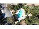 Aerial view of a community pool surrounded by lounge chairs and lush landscaping at 6855 Sperone St, Orlando, FL 32819