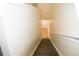 Staircase with laminate flooring leading to lower level with neutral walls and white banister at 6855 Sperone St, Orlando, FL 32819