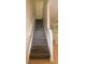 Staircase with wooden steps and white railing leading to the upper level of the home at 6855 Sperone St, Orlando, FL 32819