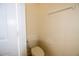 Bright toilet with a standard tank and closed white door at 6855 Sperone St, Orlando, FL 32819