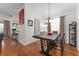 Dining area featuring hardwood floors and an open concept next to the living room and kitchen at 7736 Brofield Ave, Windermere, FL 34786