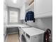 Convenient laundry room with built-in shelving, countertop, and modern washer and dryer at 7736 Brofield Ave, Windermere, FL 34786