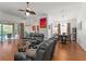 Open concept living room and dining area featuring hardwood floors and a view to an outside pool area at 7736 Brofield Ave, Windermere, FL 34786