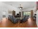 Spacious living room featuring hardwood floors, a ceiling fan, and sliding glass doors leading to the outdoors at 7736 Brofield Ave, Windermere, FL 34786