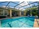 Sparkling screened-in pool with a hot tub and covered patio for relaxing or entertaining outdoors at 7736 Brofield Ave, Windermere, FL 34786