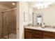 Bathroom featuring a double vanity, walk-in shower, and neutral tones, creating a serene atmosphere at 8874 Qin Loop, Kissimmee, FL 34747