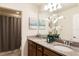 Well-lit bathroom with a double vanity, granite countertop, and decorative accents creating a relaxing space at 8874 Qin Loop, Kissimmee, FL 34747