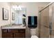 Well-lit bathroom featuring a granite countertop, modern vanity, shower stall, and updated fixtures at 8874 Qin Loop, Kissimmee, FL 34747