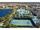 Stunning aerial view of the community featuring pool, splash pad, lake and various outdoor activities at 8940 Rhodes St, Kissimmee, FL 34747