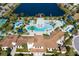 Aerial view of the community pool with a lazy river, water slides, pool furniture, and a splash pad at 8940 Rhodes St, Kissimmee, FL 34747