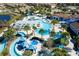 Aerial view of the community pool with water slides, lazy river, splashpad, and covered seating at 8940 Rhodes St, Kissimmee, FL 34747