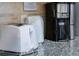 Close-up of modern kitchen appliances including a toaster, kettle, and coffee maker on granite countertops at 8940 Rhodes St, Kissimmee, FL 34747