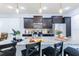 Stylish kitchen island with granite countertops, dark wood cabinets, and pendant lighting at 8940 Rhodes St, Kissimmee, FL 34747