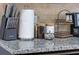 Kitchen counter with granite, paper towels, knife block and decor at 8940 Rhodes St, Kissimmee, FL 34747