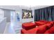 Bright living room features a bold red sectional sofa and unique Mickey Mouse themed decor at 8940 Rhodes St, Kissimmee, FL 34747