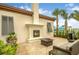 Outdoor fireplace on a large patio with exterior seating and landscaping at 8940 Rhodes St, Kissimmee, FL 34747