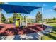 Community playground with a slide and various play structures under a shaded area at 8940 Rhodes St, Kissimmee, FL 34747