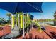 Community playground with slides, climbing bars, and covered seating, with a lake in the background at 8940 Rhodes St, Kissimmee, FL 34747